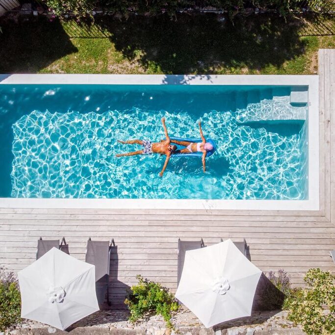 two person swim in the pool. View from above, couple men and women in swimming pool